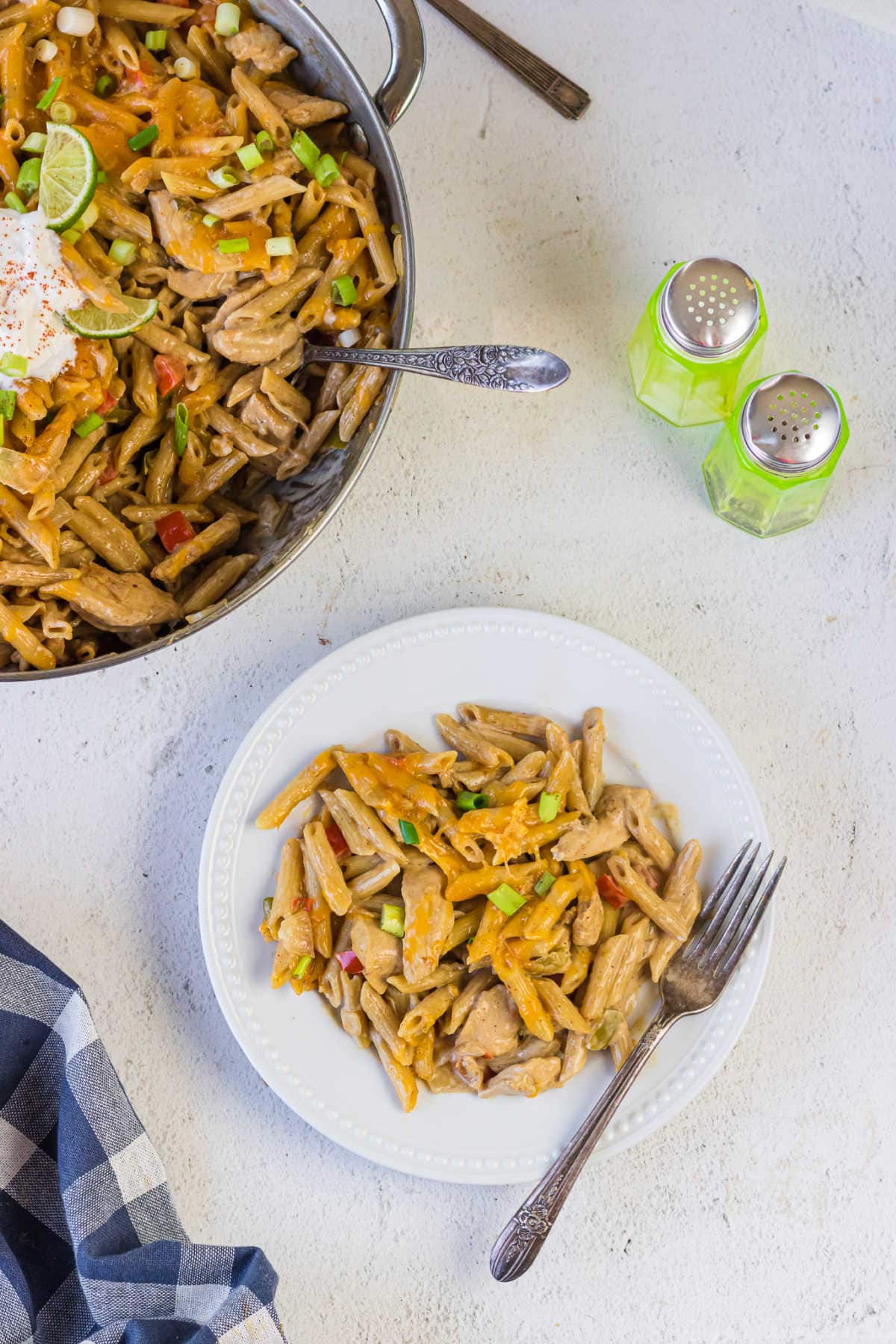 Overhead view of a serving of chicken fajita pasta on a plate.