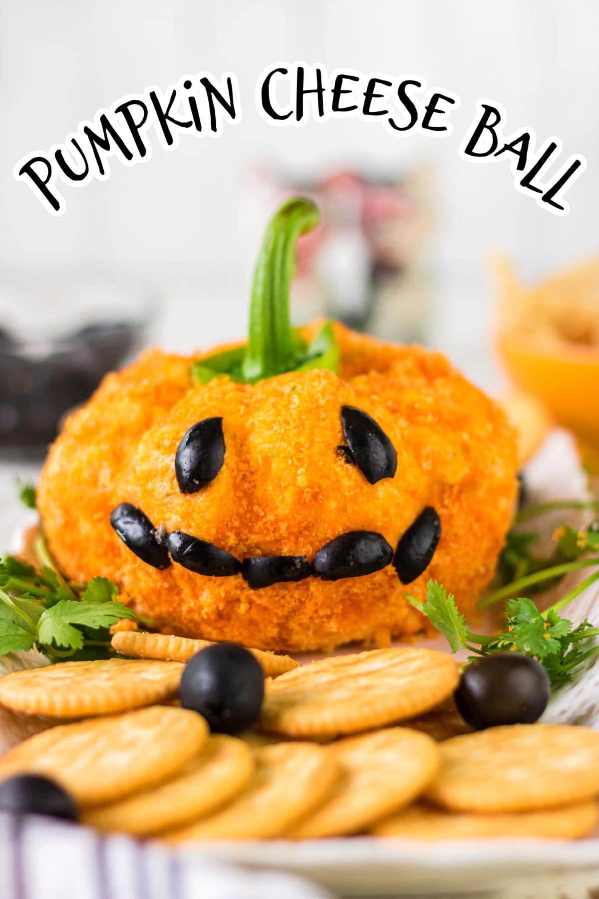 Side view of the pumpkin jack-o-lantern with a face made from ripe olives.