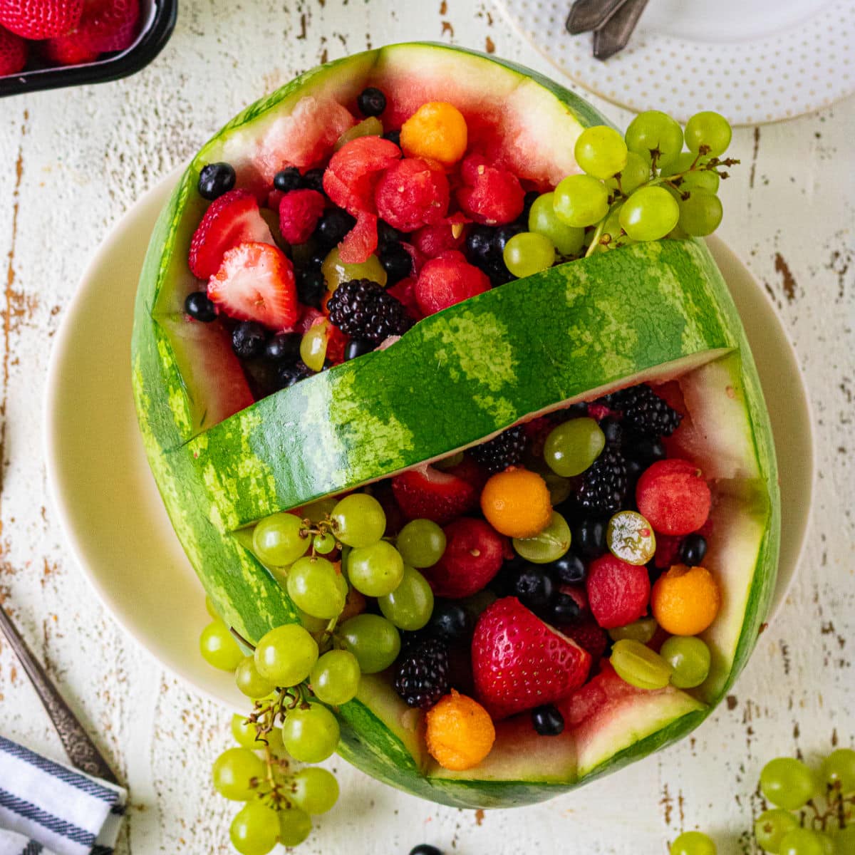 Overhead view of the finished watermelon basket filled with an assortment of fruit.