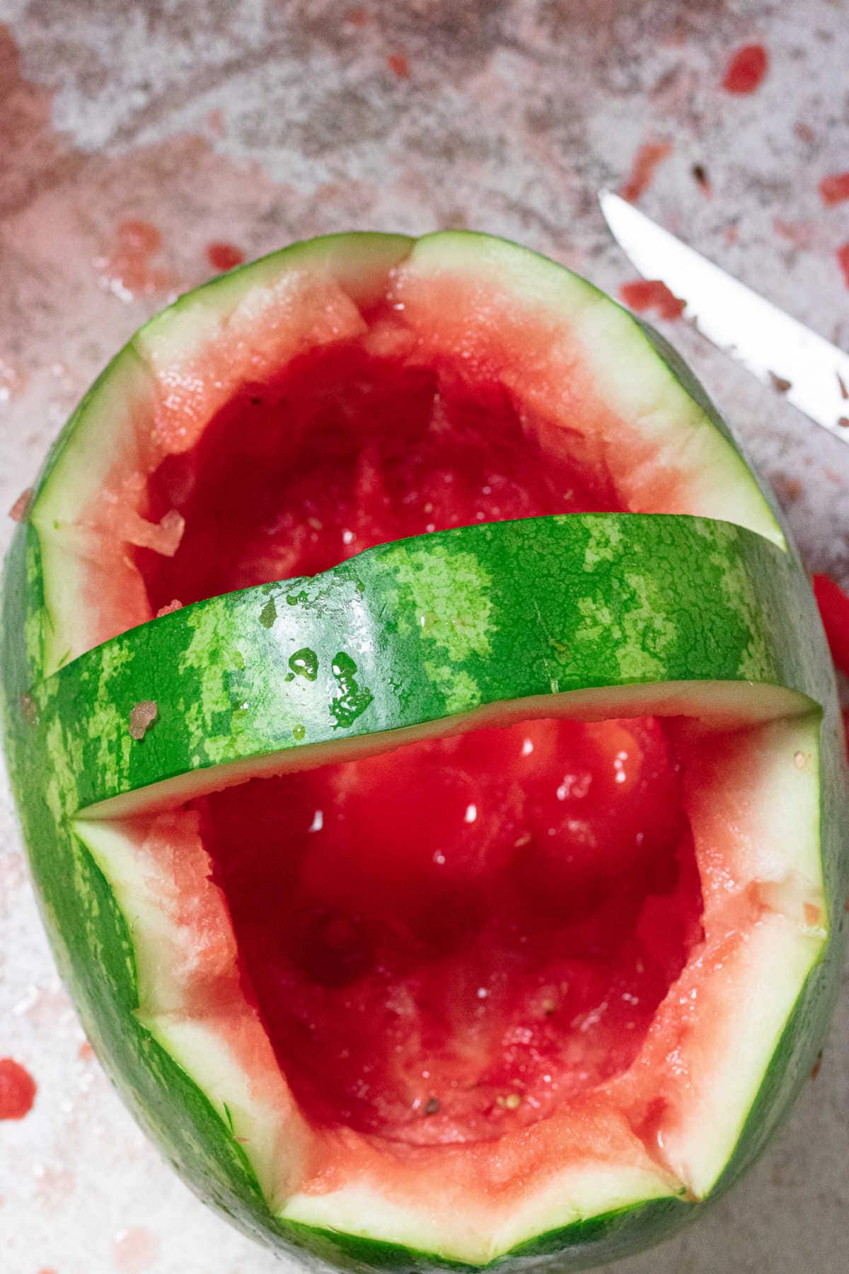 Overhead view of a hollowed out rind forming a watermelon basket.