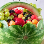 A finished watermelon basket with a text overlay for Pinterest.