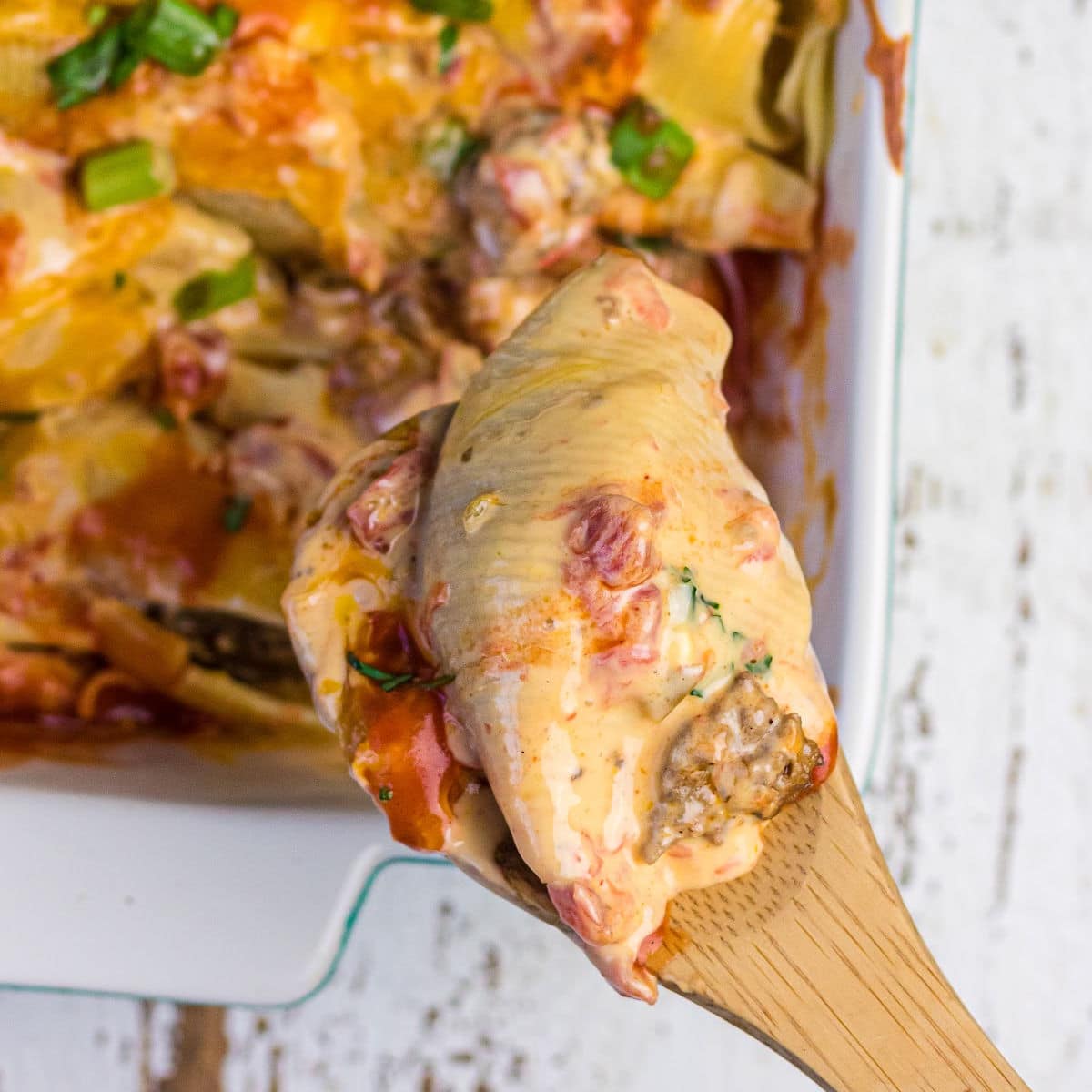 Close up of a serving spoon removing some of the casserole for the feature image.