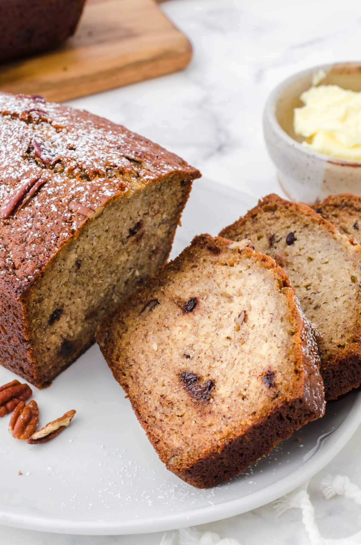 Closeup of slices of banana bread on a plate showing the moist interior.