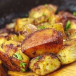 Pinterest pin with title text overlay showing golden fried potatoes in a skillet.