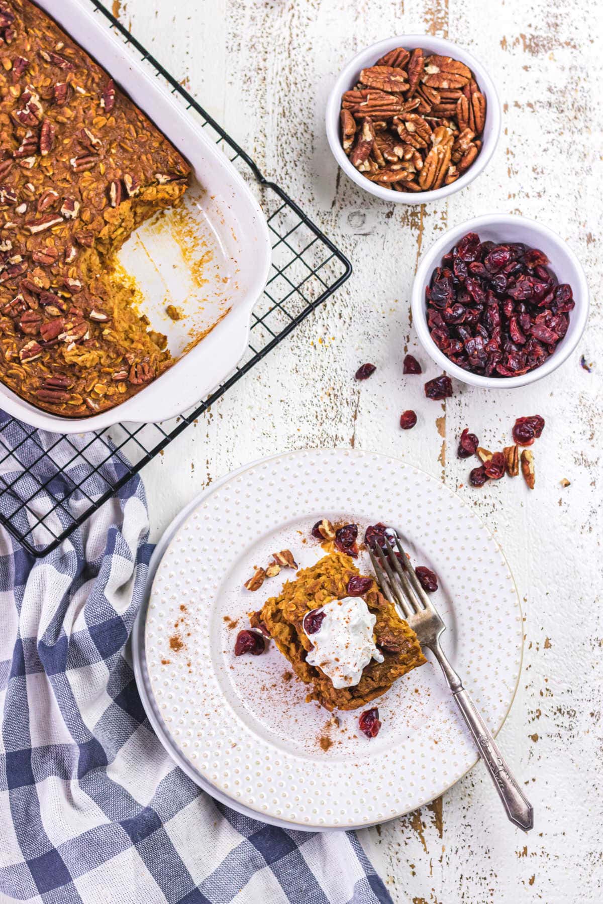 Overhead view of a breakfast table with a plate of baked oatmeal.