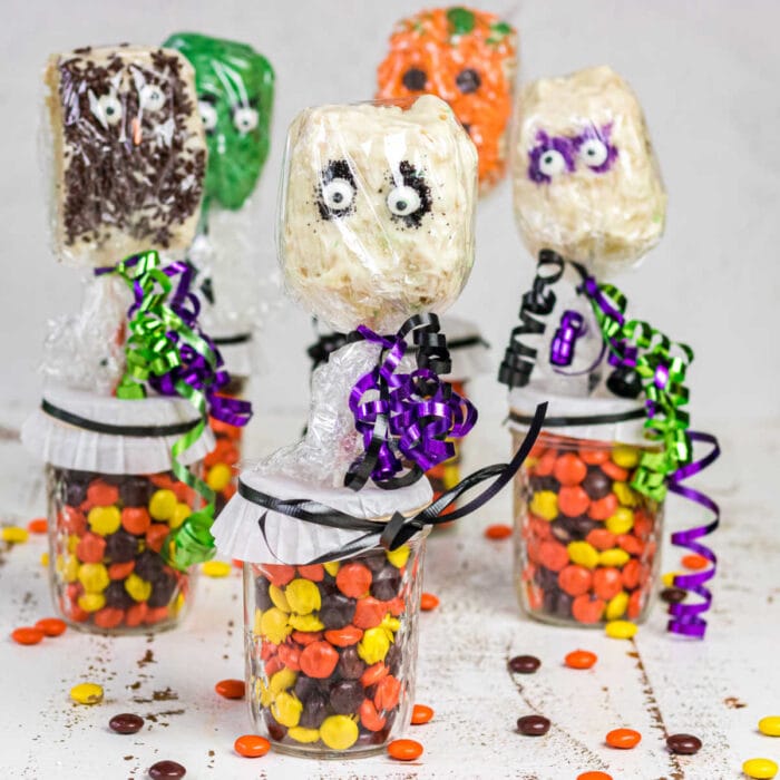 A collection of the finished Halloween Rice Krispie Treats on sticks.