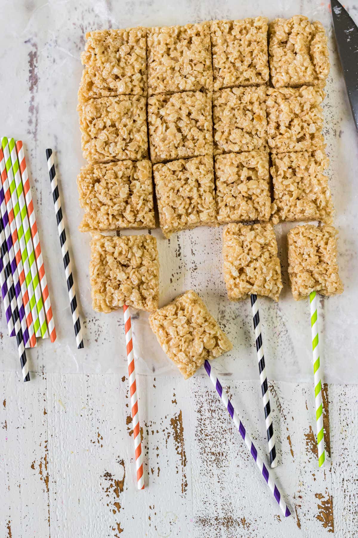 Undecorated treats with straws pushed in as sticks.