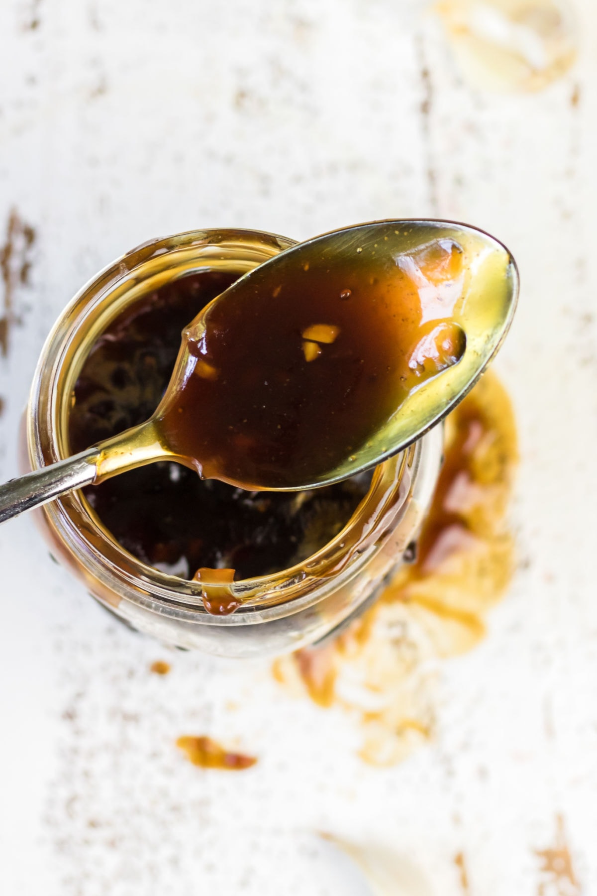 Overhead view of a spoonful of teriyaki sauce.