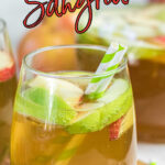 Closeup pf a glass of apple sangria with a text overlay for Pinterest.