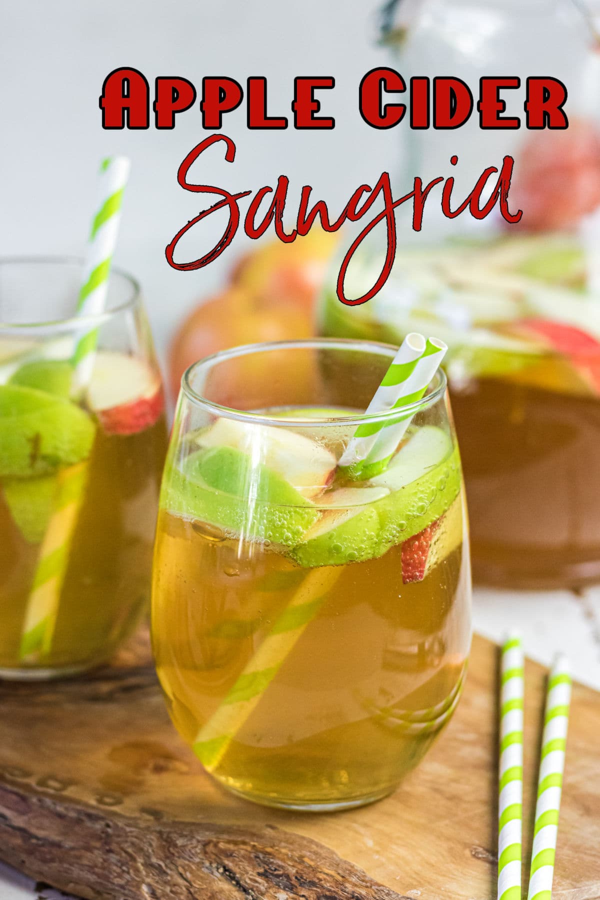 Close up of a glass of the sangria with apples floating in it. Title text overlay.