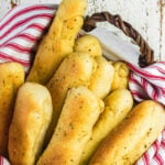 Breadsticks in a basket with text overlay for Pinterest.
