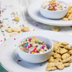 Side view of two servings of the dip on plates with cookies.