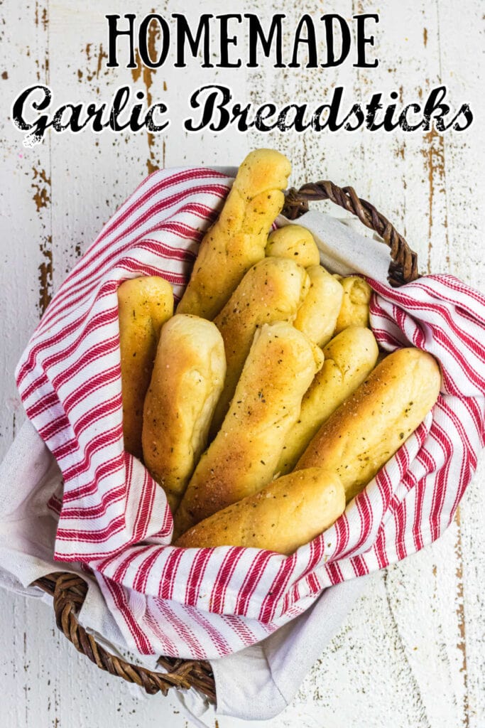 Homemade garlic breadsticks in a basket with title text overlay.