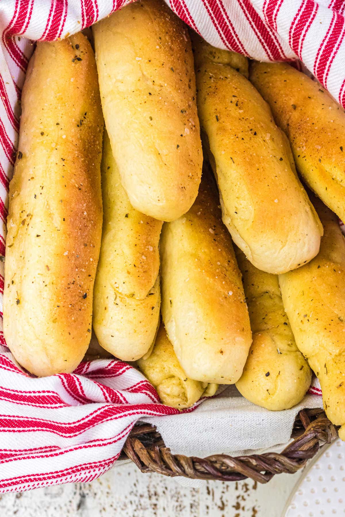 Closeup of golden brown breadsticks in a basket.