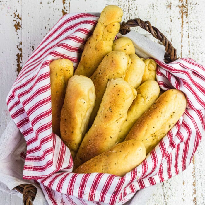 A basket full of garlic breadsticks.