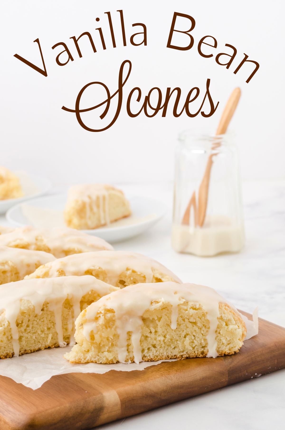 Finished scones with glaze dripping down the sides on a wooden cutting board. Title text overlay.