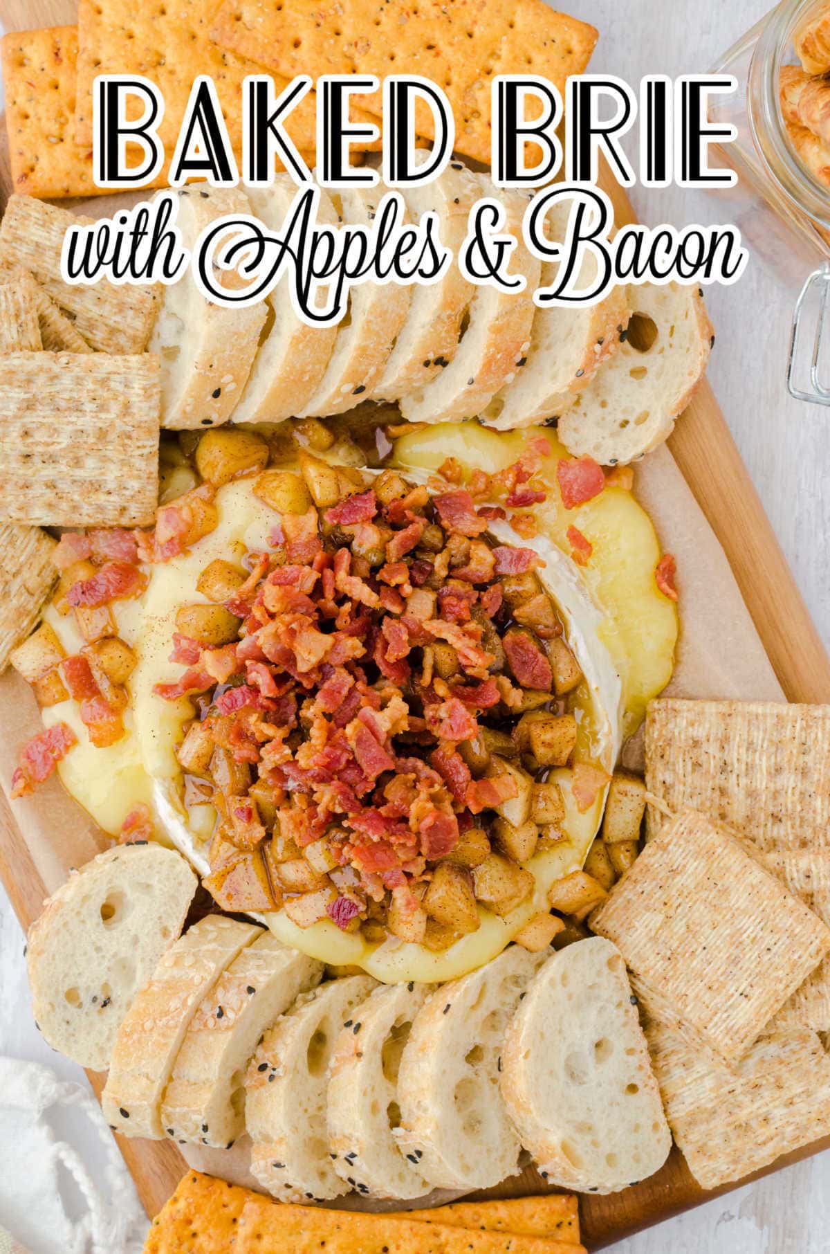 Overhead view of baked brie with title text overlay.