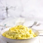 Side view of mashed potatoes with text overlay for pinning on Pinterest.