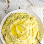Overhead view of mashed potatoes with text overlay for pinning on pinterest .