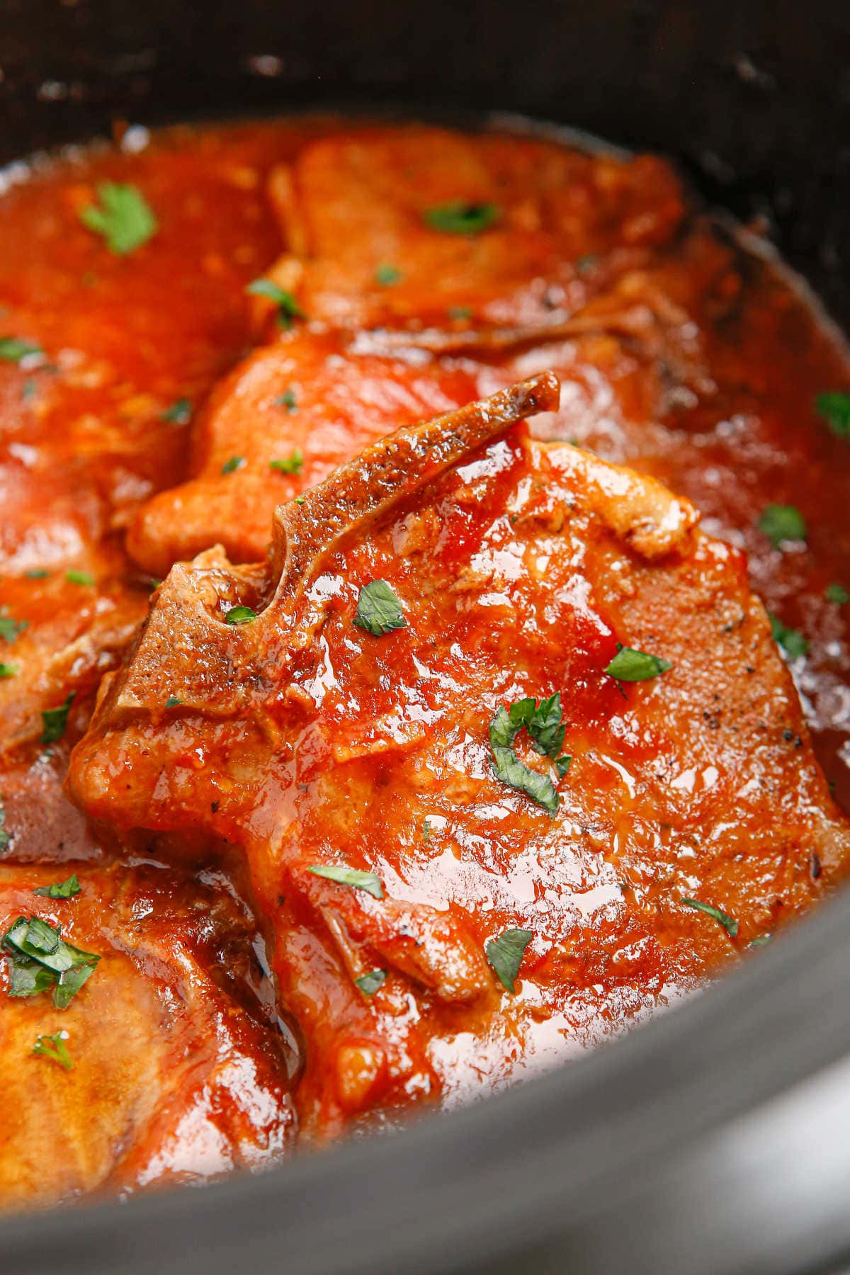 Closeup of the pork chops in the slow cooker.