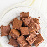 Overhead view of a plate of fudge with a text overlay for pinterest.