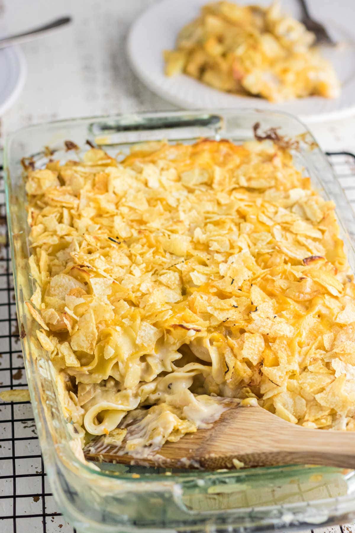 A serving of casserole being taken from the dish showing the creamy insides.