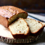 Slices of crunchy peanut butter banana bread on a serving dish.