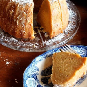 A sweet potato pound cake with a slice removed showing the velvety interior.