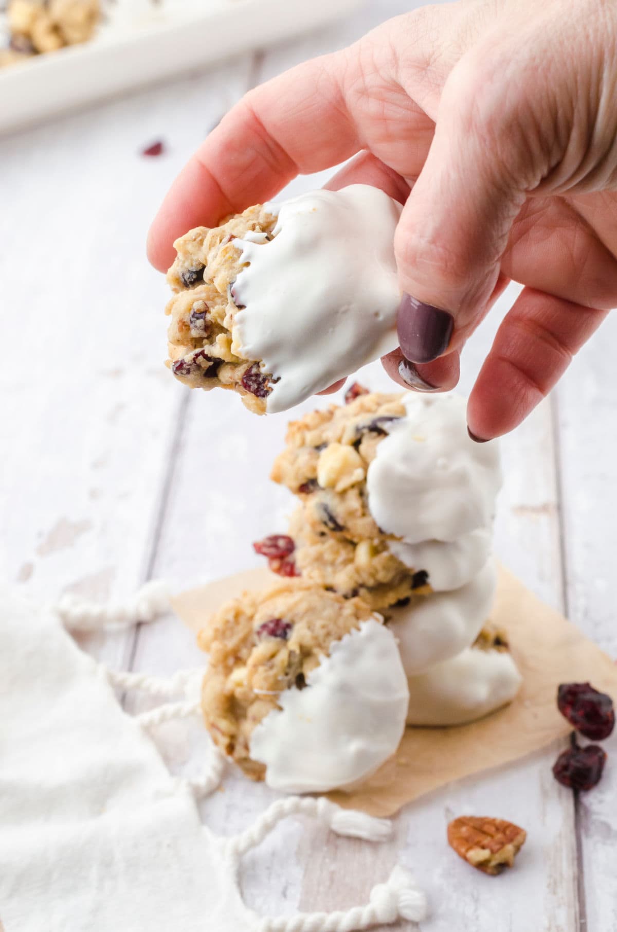 A person picking up a cookie.