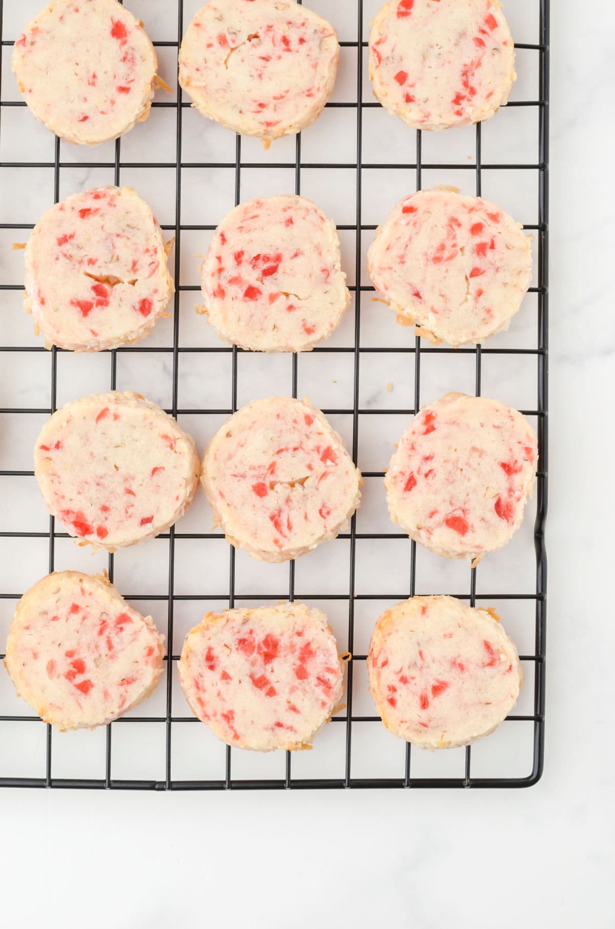 Overhead view of cookies cooling on a rack.