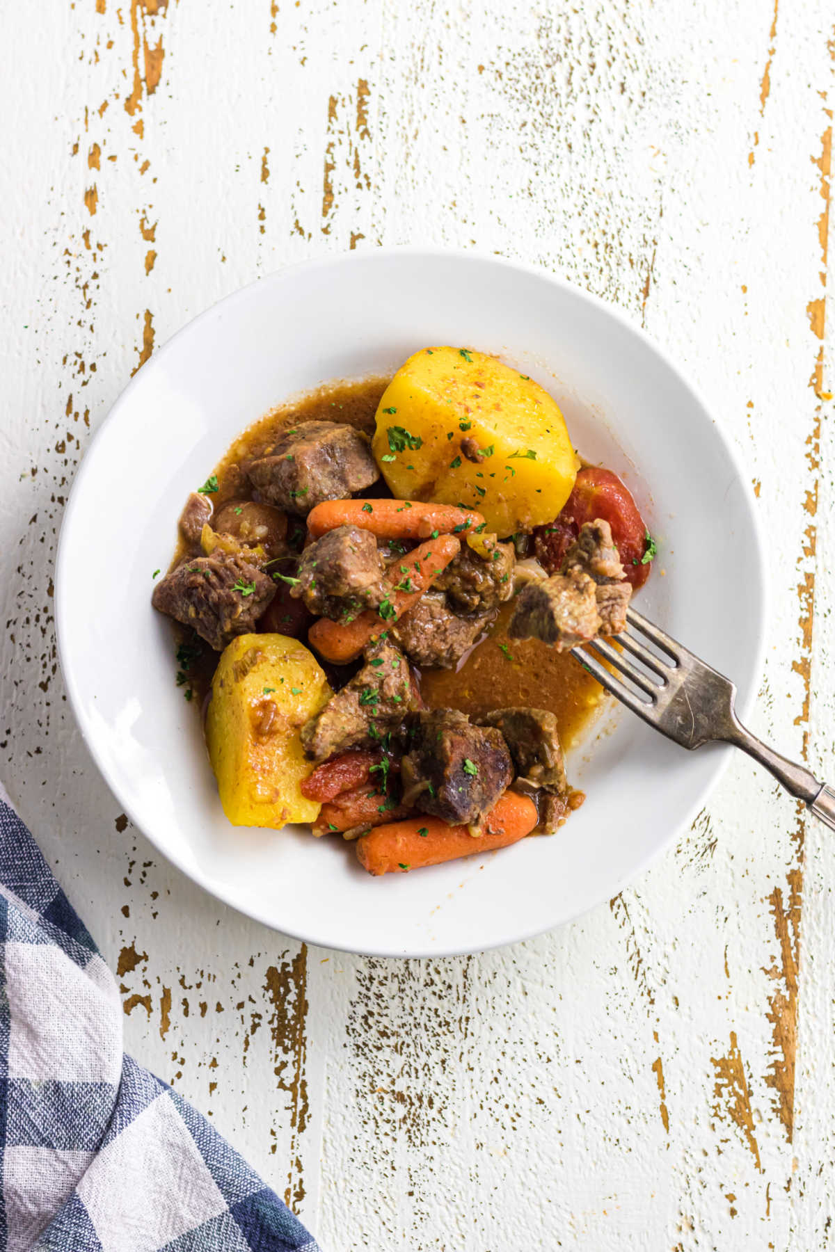 Decorative. Overhead view of beef stew in a bowl with a fork.