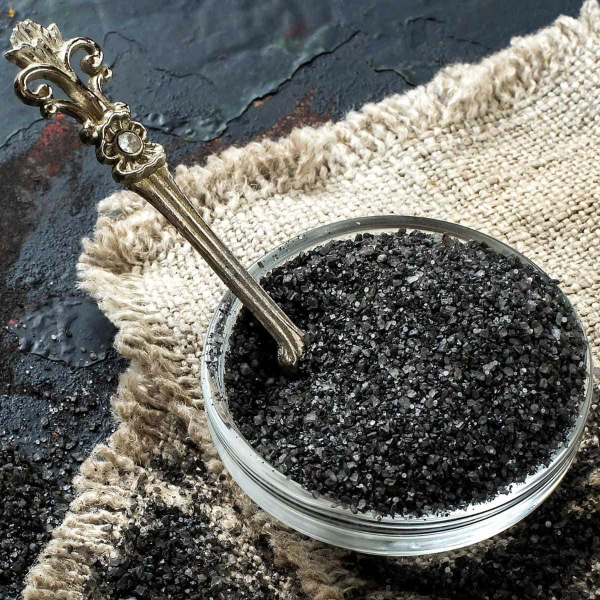 Closeup of black salt in a dish.