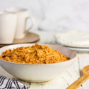 Side view of the sweet potatoes with a wooden spoon.