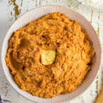 Overhead view of sweet potatoes in a white bowl.