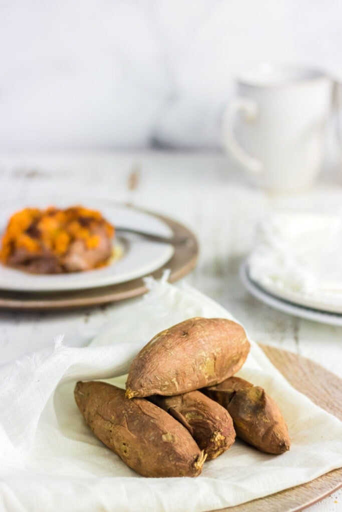 A pile of baked sweet potatoes on a napkin.