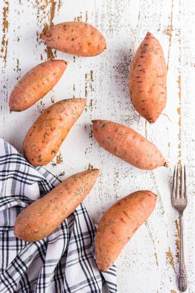 Overhead view of raw sweet potatoes.