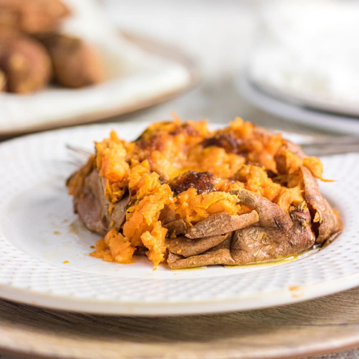 Closeup of baked sweet potato with butter in it.