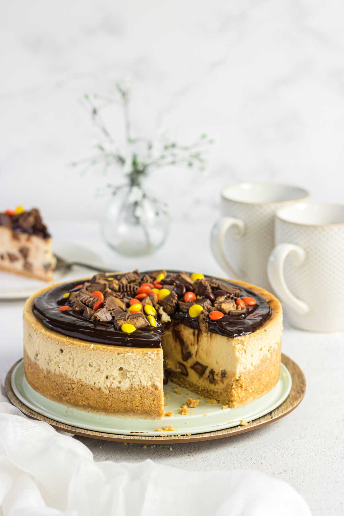 Peanut butter cup cheesecake with a slice removed.