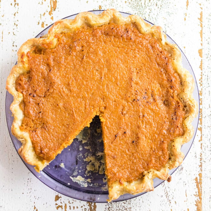 Overhead view of sweet potato pie with a slice removed.