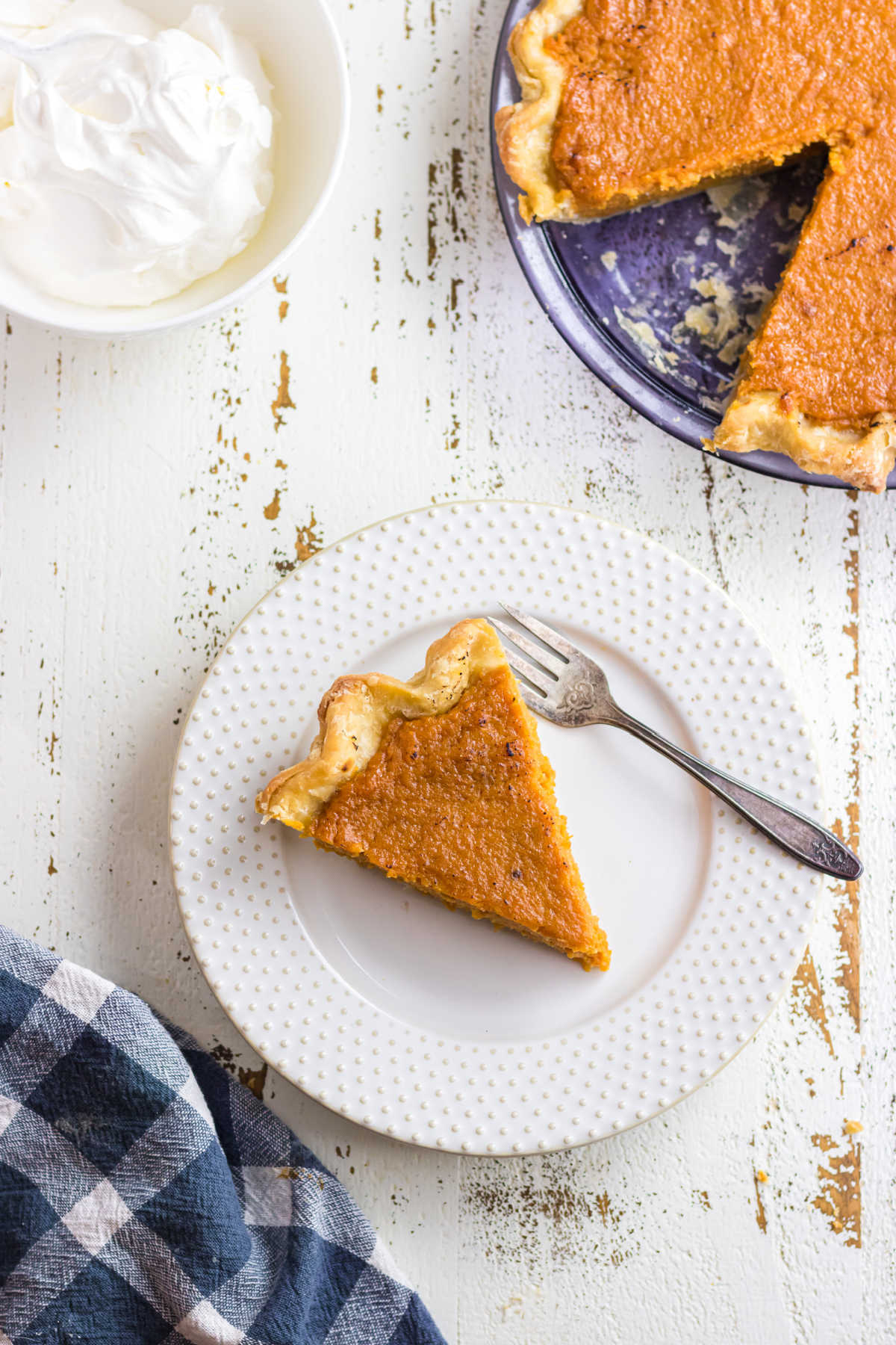 Overhead view of a slice of pie on a white plate.