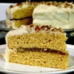 A slice of caramel cake showing the pecan filling.