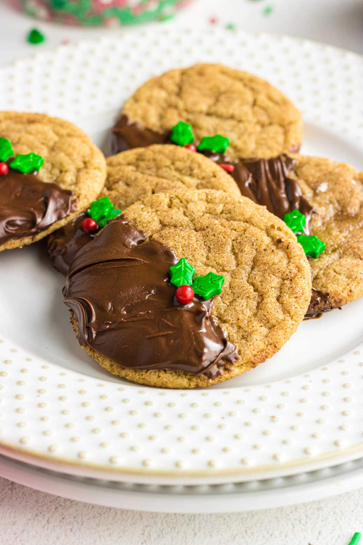 Closeup of cookies that have been dipping halfway in chocolate.