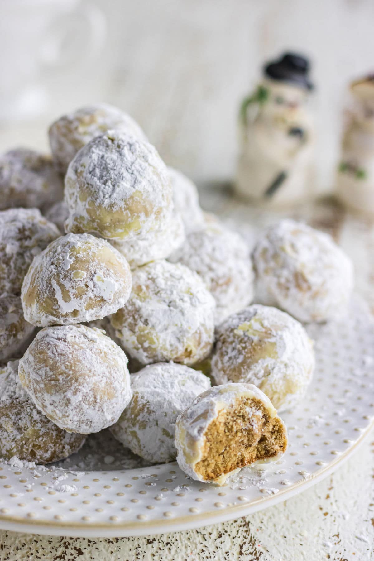 A plate of cookies covered in powdered sugar.