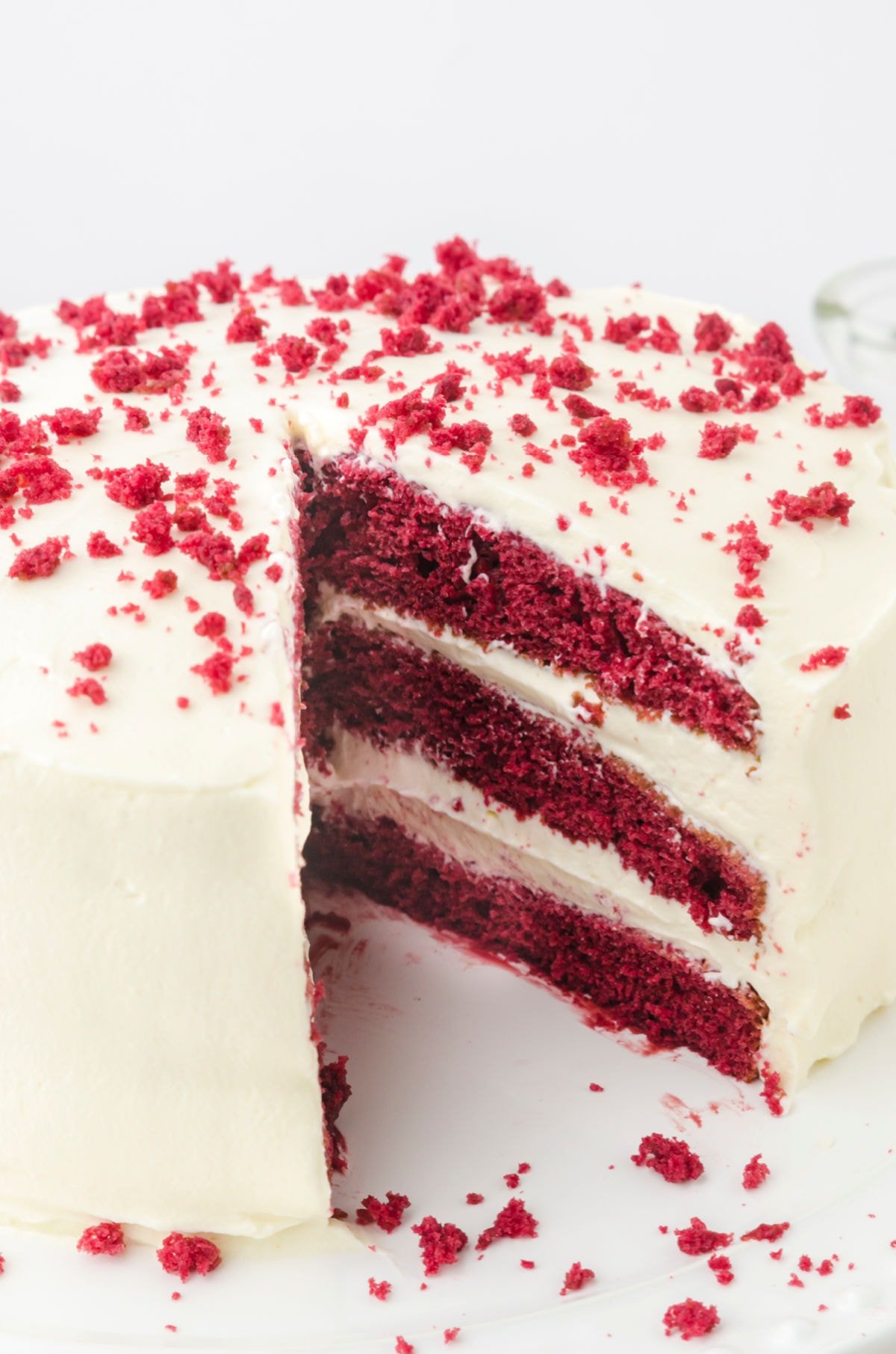 Finished cake with a sliced removed to show layers of cake and frosting.