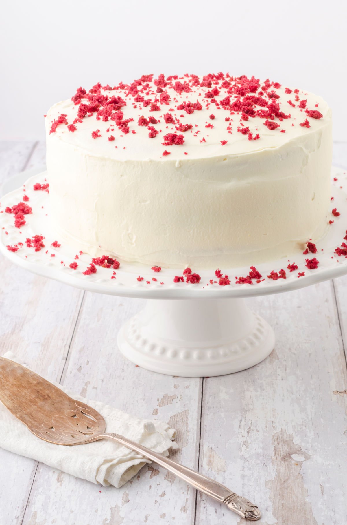 Finished cake, unsliced, on a cake stand.