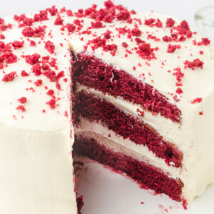 Close up of cut cake showing the layers of cake and frosting.