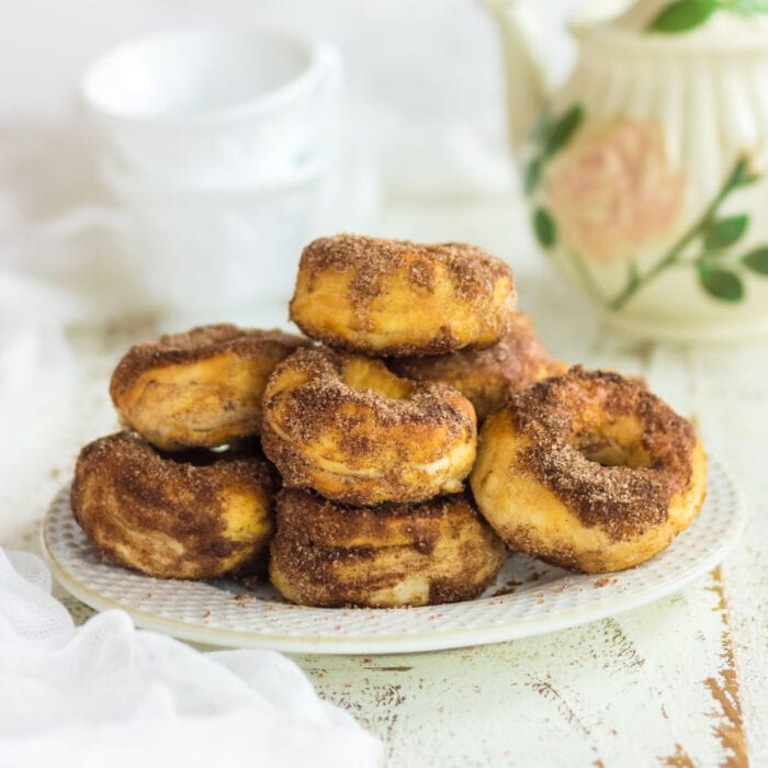 Stack of cinnamon donuts on a plate for feature image.