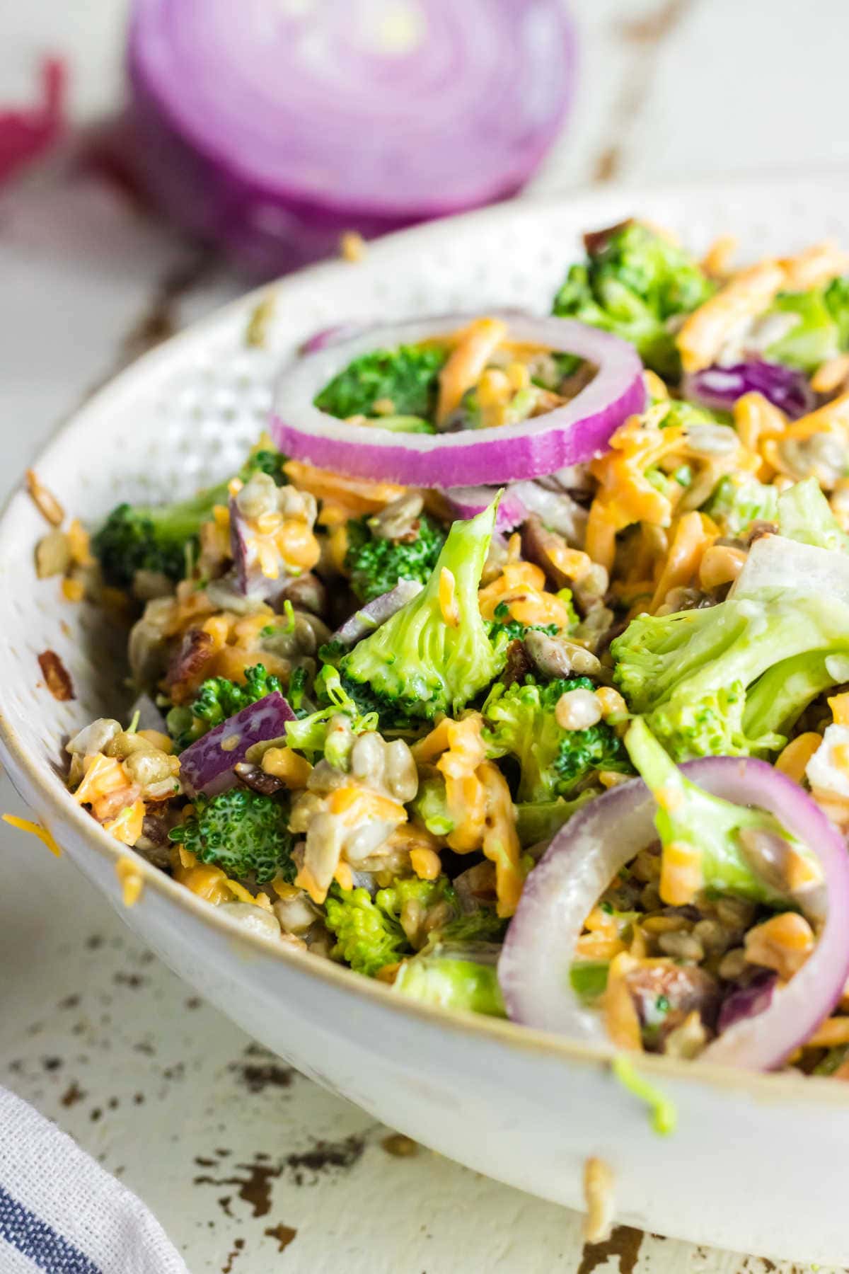 Closeup side view of keto broccoli salad showing the textures of the mixed ingredients.