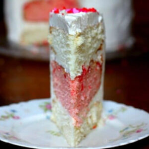 Closeup view of cherry almond cake showing different colored layers.