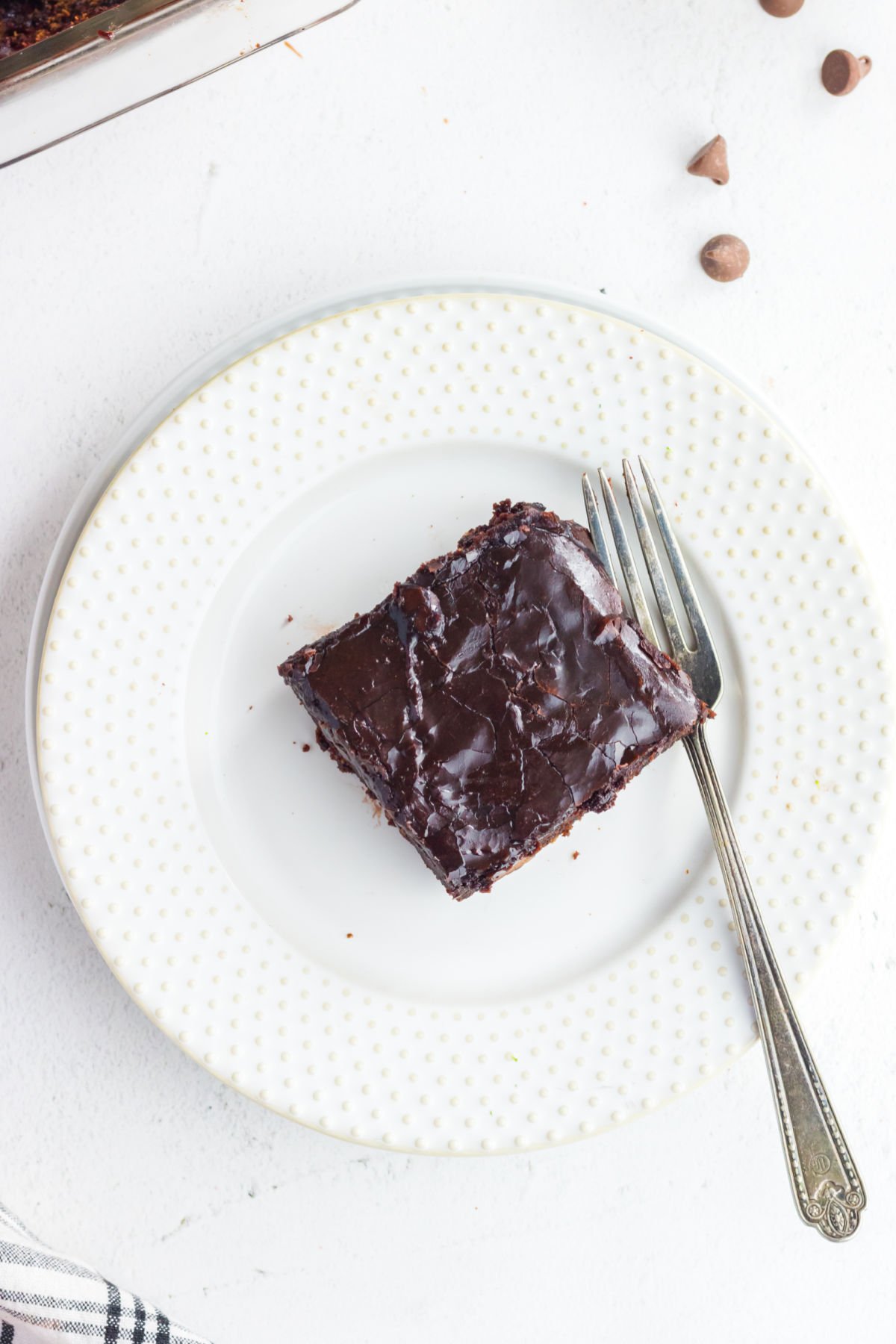 A serving of cake on a white plate.